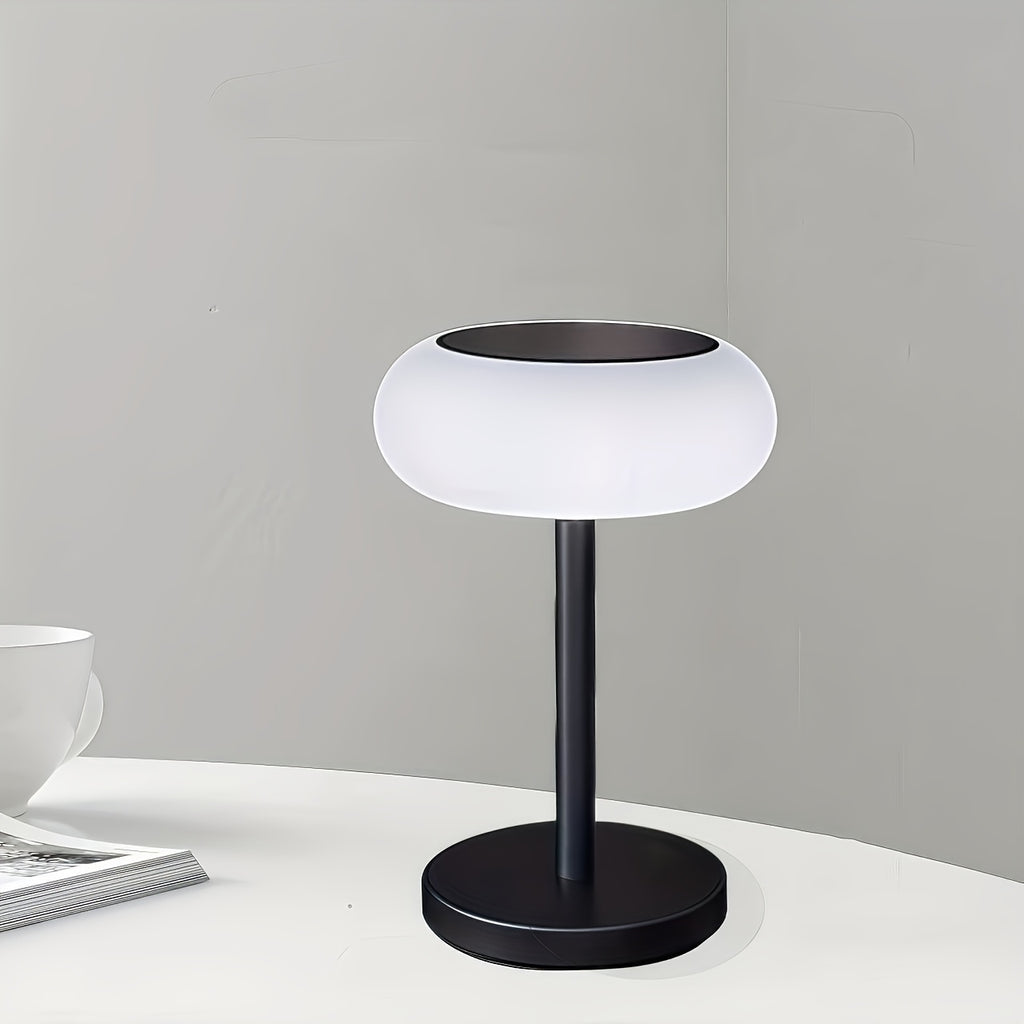A rechargeable table lamp with smart remote control and dusk-to-dawn activation sensor. This wireless bedside lamp can be powered by solar energy and offers adjustable brightness, perfect for camping.